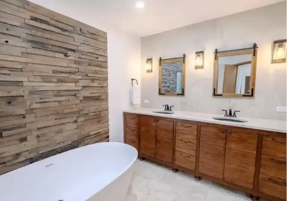 Double vanity with walnut cabinetry and bronze fixtures