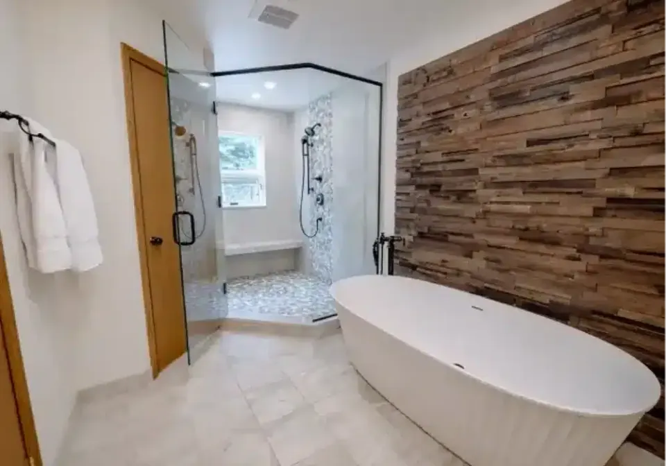 Freestanding tub beside a reclaimed wood accent wall