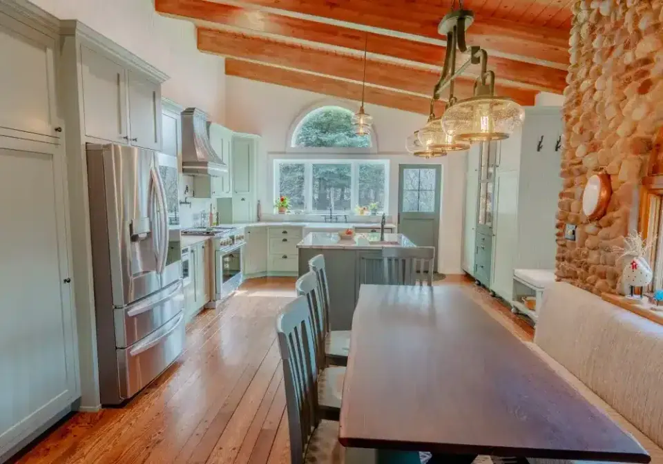 Remodeled kitchen and dining area with a stone accent wall