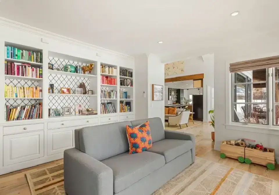 Living room with a wall of built-in bookshelves
