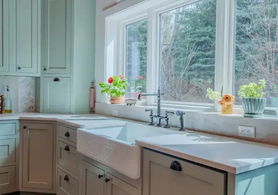 Sage green kitchen with copper range hood