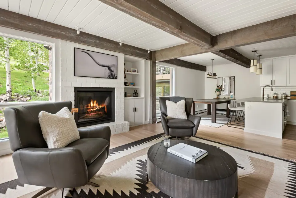 Living room with beamed ceiling and fireplace