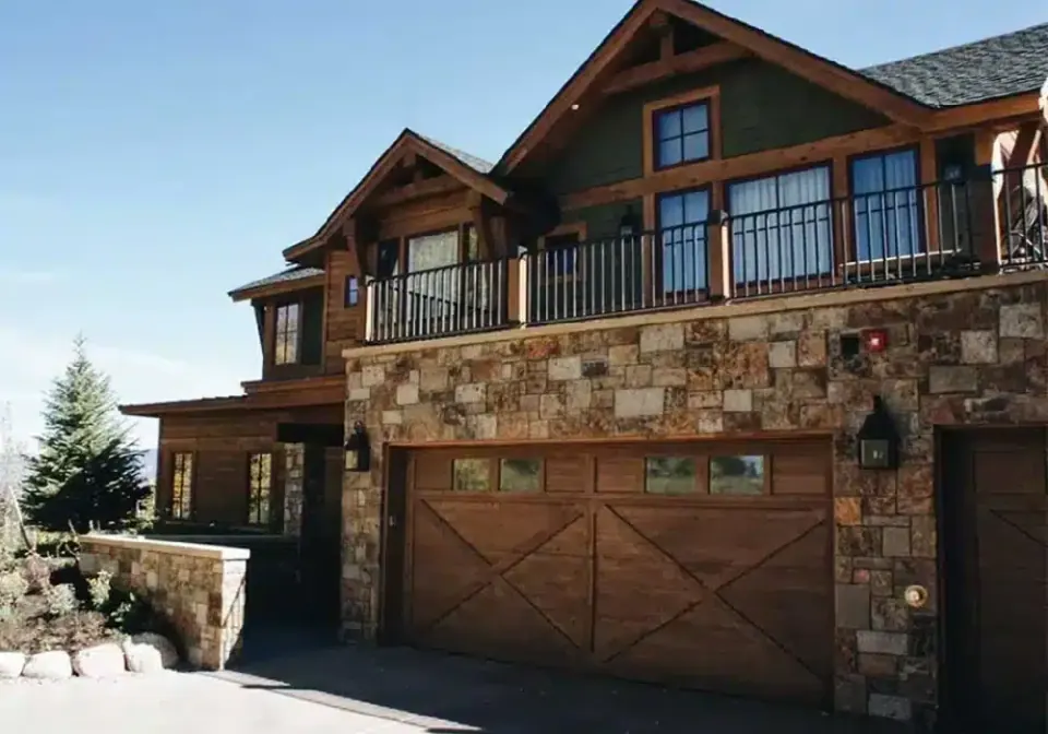 Custom home with stone garage and timber balcony